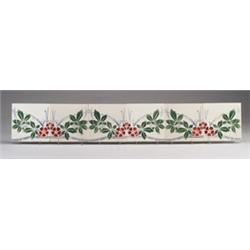 Six SAINT-AMAND (France) tiles forming a frieze, decorated in pairs with a stencil of red flowers…