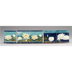 Two friezes of German majolica tiles embossed with waterlilies, one of three tiles with yellow bl…