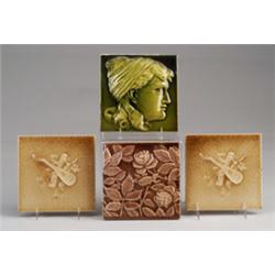 Four American embossed tiles, including a pair of AMERICAN ENCAUSTIC TILING CO. trophy tiles with…