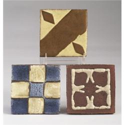 Three GRUEBY tiles, two geometric (one yellow and brown, one in blue and ivory checkers) and one …