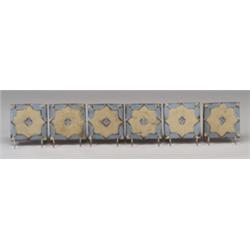 Six GRUEBY geometric red clay tiles with a white Moorish star on a pale blue ground. Unmarked. 3"…