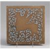 Image 1 : ROOKWOOD Faience tile depicting a winged griffin in brown clay against a blue-gray glazed ground.…
