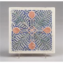 ROOKWOOD trivet tile, 1930, embossed with a floral and foliate desing in pink and green against a…