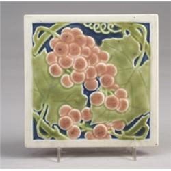 ROOKWOOD trivet tile, 1925, embossed with pink grapes and green foliage on a blue ground. Some pe…