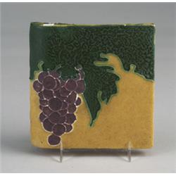 OWENS bullnose tile decorated in matte cuenca with purple grapes and green foliage on a mustard g…