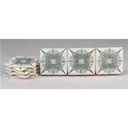 Ten GILLIOT & Cie (Hemixem, Belgium) 4 3/4" tiles, transfer-decorated with a stylized blossom on …