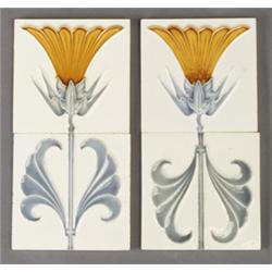Pair of T.A.W. (Germany) frieze tiles, molded with a two-part papyrus plant in amber and gray cue…