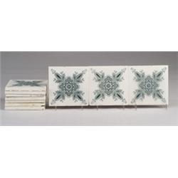 Ten German tiles transfer-printed with a floral design in green on white. Minimal crazing, a few …