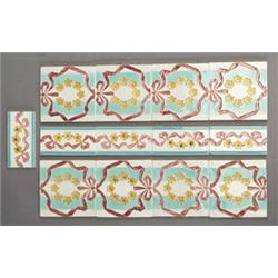 Eight Continental tiles and five matching borders impressed with a design of pink ribbons and yel…