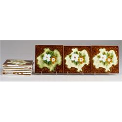 Nine BFK (Belgium) tiles embossed with brown and white roses on ivory medallion, on a brown folia…