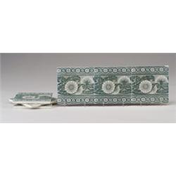 Six Belgian frieze tiles transfer-decorated with a band of daisies, in dark green on white. Surfa…