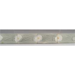 Thirty European border tiles, each embossed with white and yellow anemone against a celadon groun…