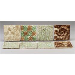 Eight American tiles molded with floral patterns and covered with mottled glazes by PROVIDENTIAL,…