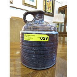 Glazed pottery jug with handle. Hand made