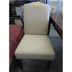 Pair of beige vinyl upholstered dining chairs