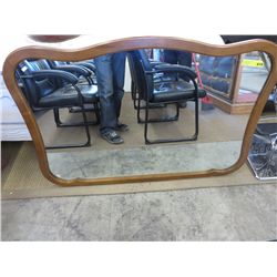 Wood framed wall mirror with scalloped edged