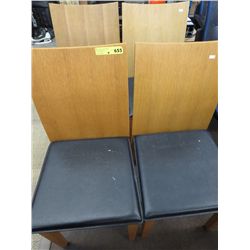 Four wood chairs with leather seats