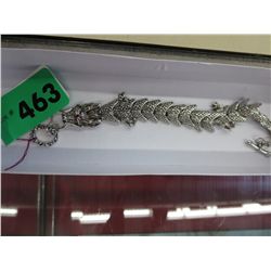 An articulating dragon bracelet with toggle clasp