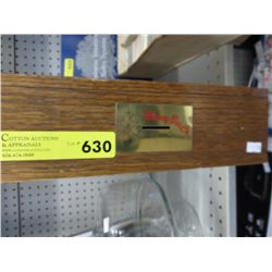 Wooden money box on rollers