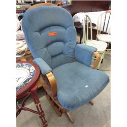 Blue upholstered gliding rocker