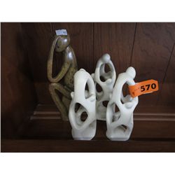 Four carved stone statues
