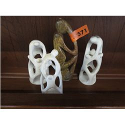 Four carved stone statues