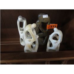Four carved stone statues