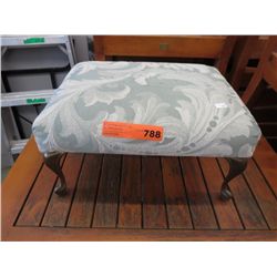 Small upholstered foot stool with metal legs