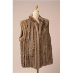 WOVEN MINK VEST The hip length vest with a mandarin collar is in caramel coloured sculpted mink w...