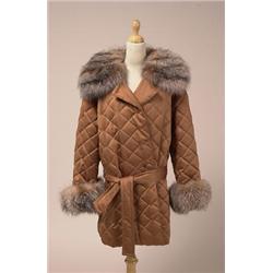 SATIN JACKET WITH FOX TRIM The mid-length, belted, double breasted jacket is in quilted copper co...