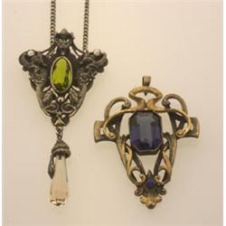 TWO ART NOUVEAU PENDANTS First, in base metal, a shield shape pendant with gryphon and grotesque...