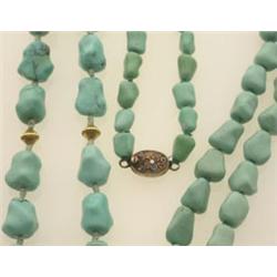 two TURQUOISE BEAD NECKLACES First, a single strand of tumbled turquoise nugget beads graduating...