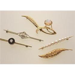 a collection of five vintage brooches First, a 14K white topped yellow gold bar pin with a round...