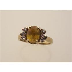 Yellow sapphire, diamond and gold ring In 14K yellow gold; a 2.27 carat oval facetted yellow sapp...