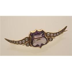 vintage amethyst, seed pearl and gold brooch In 14K yellow gold, an amethyst carved in the shape...