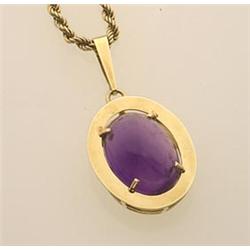 amethyst and gold pendant and chain A 14K yellow gold flat, polished oval frame having a double g...