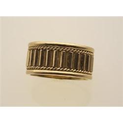 fancy gold band style ring In 18K yellow gold, the 9.2 mm. wide band has a fluted centre section,...