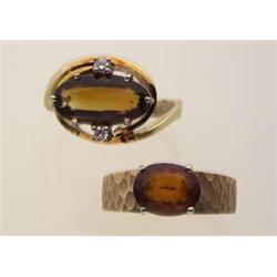 two gold and citrine rings Both rings are in 14K yellow gold. The first is a wrap around design l...