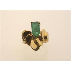emerald and gold ring The custom made ring in 18K yellow gold features an emerald cut emerald wei...