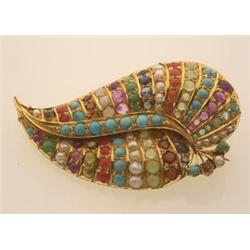 gold and gemstone brooch In 14K yellow gold, the leaf form brooch is set with assorted seed pearl...