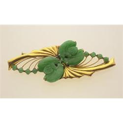 vintage jade and gold brooch Stamped 14K, with a high karat gold finish; the navette shape design...
