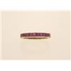Image 1 : gold and ruby band style ring In 14K yellow gold, a simple band is channel set with eleven square...