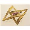 Image 1 : vintage gold and ruby brooch In 18K yellow gold, the brooch is designed as two engraved and textu...