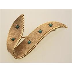 gold and turquoise brooch The 14K yellow gold Florentine finish brooch is in a stylized three dim...
