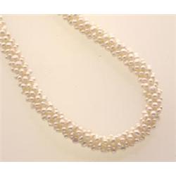 seed pearl necklace A 14K yellow gold navette shape filigree clasp suspends a woven tubular singl...
