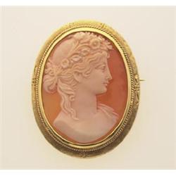 shell cameo brooch/pendant The engraved and rope edged 18K yellow gold frame has a decorative hin...