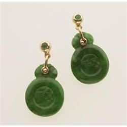 jadeite and gold earrings In 14K yellow gold, with posted backs for pierced ears; studs containin...