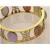 Image 1 : gold and multicoloured jadeite bracelet In 14K yellow gold, the round hinged bangle is set with s...