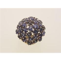 sapphire and gold cluster ring The 18K yellow gold open shouldered mount supports a round cluster...