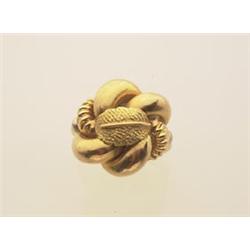 gold cocktail ring In 18K yellow gold, a textured and polished knot design is surmounted with an...